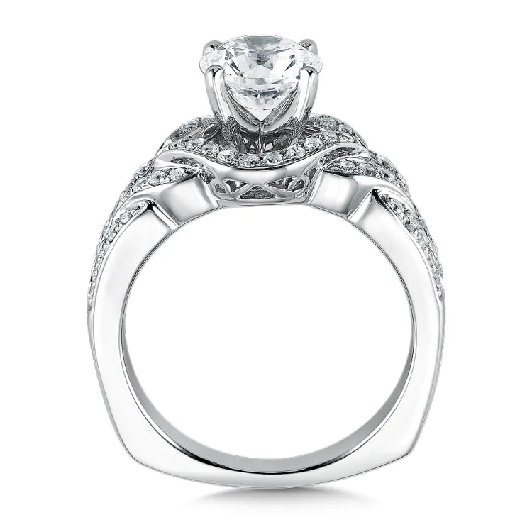 An open weave pattern of pave-set diamonds frames the luminous center stone making this ring shine.
