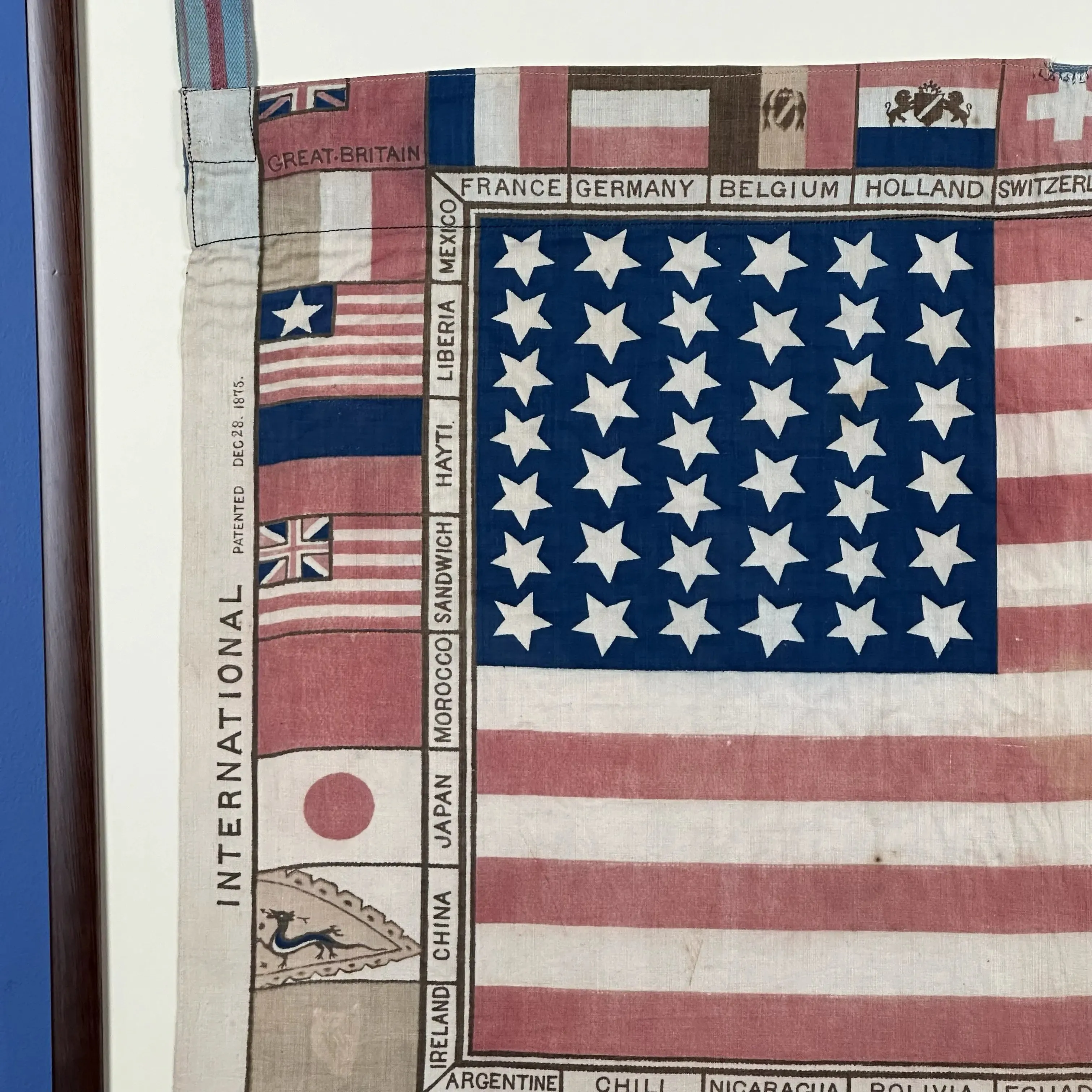 Printed for the 1876 Centennial Exhibition: US flag surrounded with the flags of participating nations — Framed