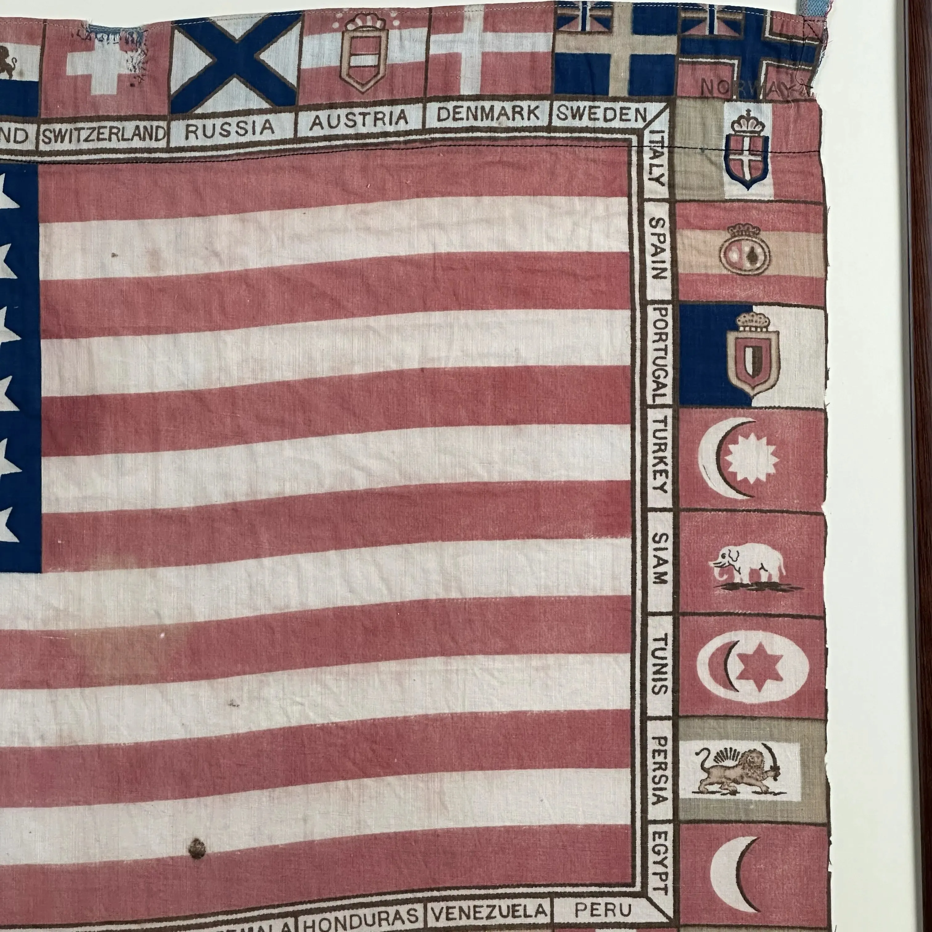 Printed for the 1876 Centennial Exhibition: US flag surrounded with the flags of participating nations — Framed
