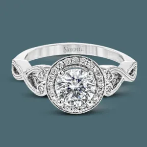 This remarkably beautiful white gold ring features intricate milgrain details alongside a lovely halo of .06 ctw of round white diamonds.