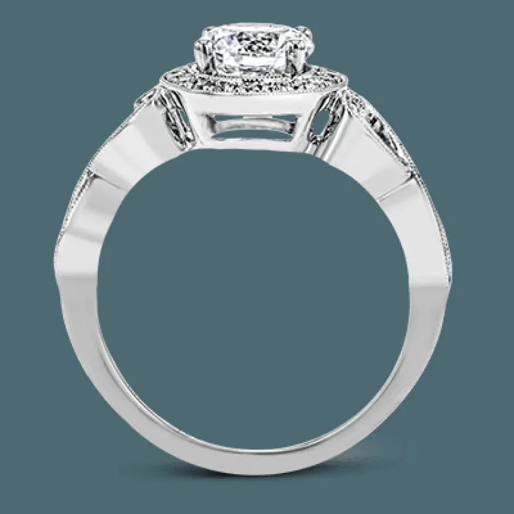 This remarkably beautiful white gold ring features intricate milgrain details alongside a lovely halo of .06 ctw of round white diamonds.